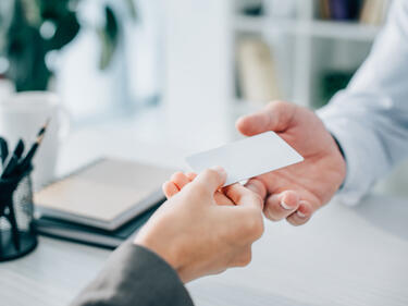 Someone giving an empty card to another person