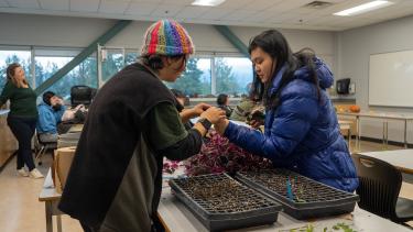 Indigenous Students - UFV Visit 2023 Two female students inspecting a plant within the classroom
